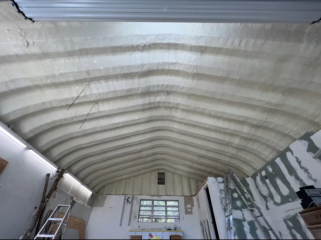 Spray polyurethane foam applied to the underside of a metal roof deck in Long Branch